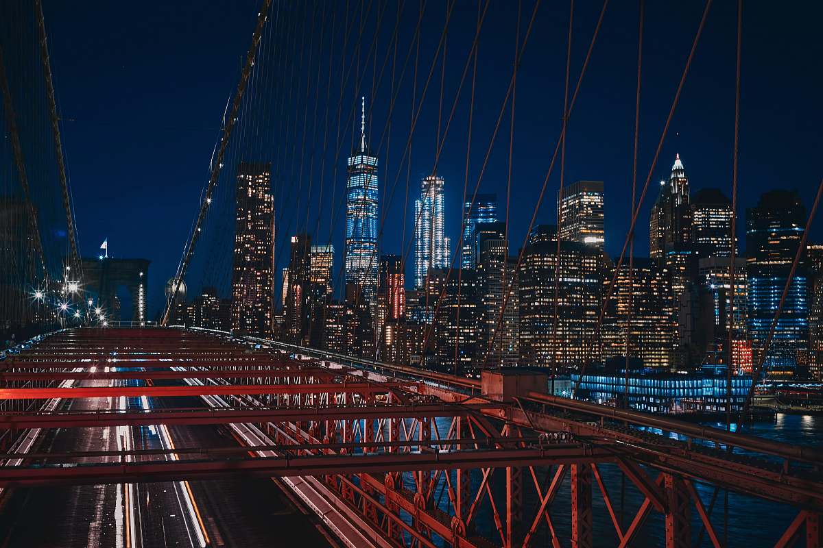 brooklyn bridge bridge near city buildings during nighttime new york